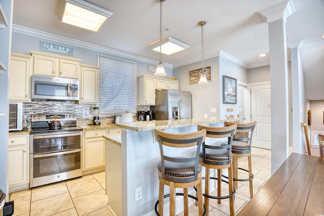 kitchen with cream cabinets, light tile patterned flooring, stainless steel appliances, ornamental molding, and tasteful backsplash