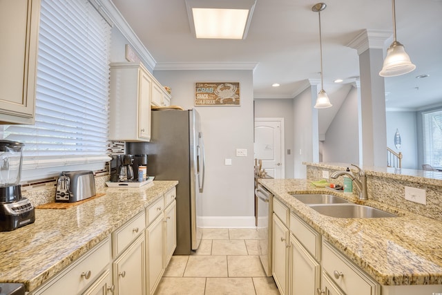 kitchen featuring cream cabinetry, decorative light fixtures, stainless steel dishwasher, ornamental molding, and a sink