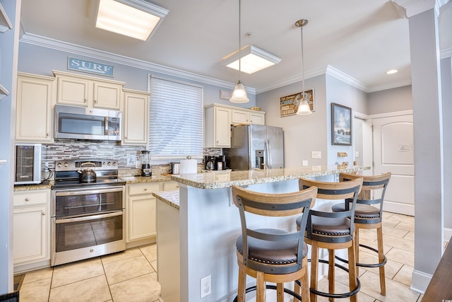 kitchen featuring decorative backsplash, stainless steel appliances, cream cabinetry, and ornamental molding