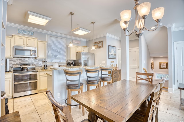 dining area featuring light tile patterned floors, crown molding, and an inviting chandelier