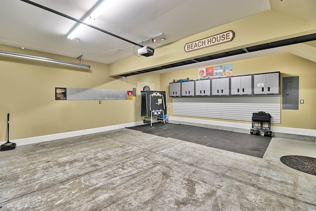 garage featuring a garage door opener, electric panel, and baseboards