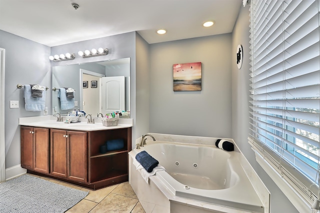 full bath featuring double vanity, tile patterned flooring, a tub with jets, and a sink