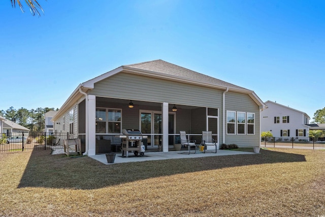 rear view of property featuring a patio area, a fenced backyard, a ceiling fan, and a yard