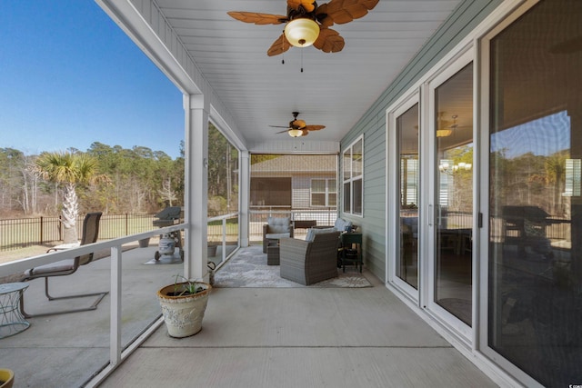 view of patio with ceiling fan and fence