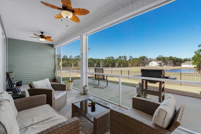 view of patio / terrace with a fenced backyard, ceiling fan, a water view, and an outdoor hangout area