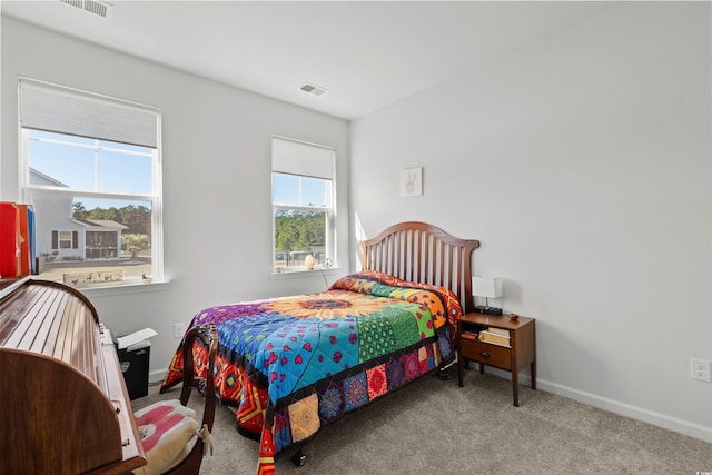 bedroom with baseboards, visible vents, and carpet flooring