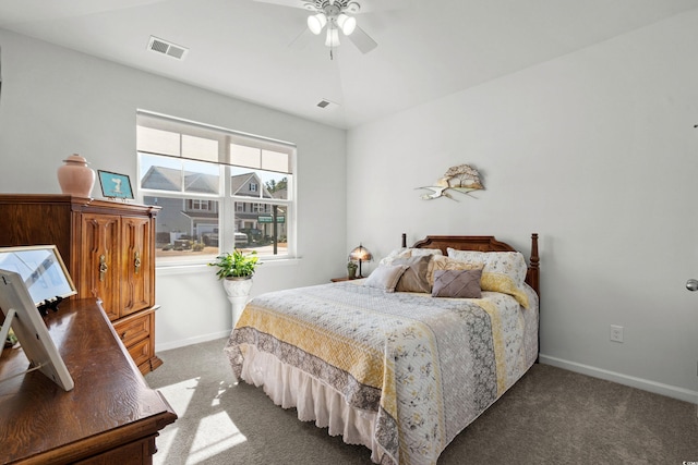 carpeted bedroom featuring a ceiling fan, visible vents, and baseboards