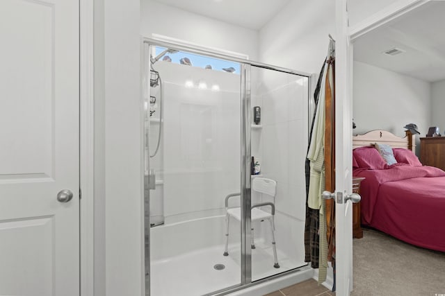 ensuite bathroom with a shower stall, visible vents, and ensuite bathroom