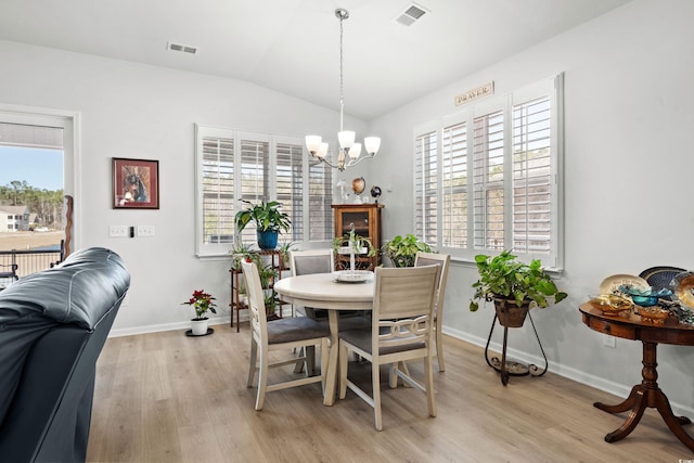 dining room with a chandelier, a healthy amount of sunlight, visible vents, and light wood-style floors