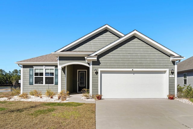 craftsman house with a garage and concrete driveway