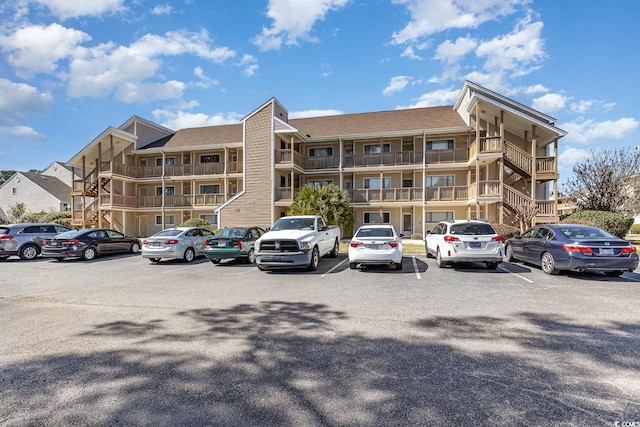 view of building exterior with uncovered parking