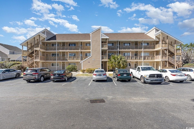 view of building exterior with uncovered parking