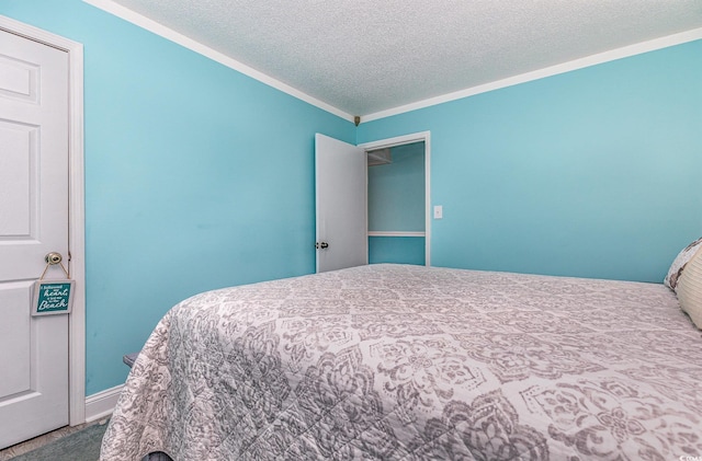 bedroom featuring a textured ceiling and crown molding