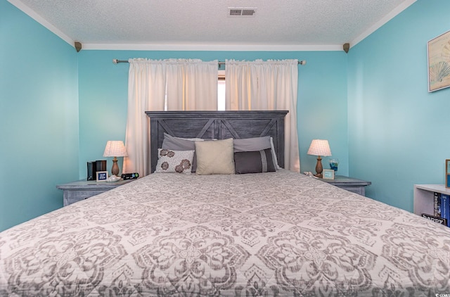 bedroom featuring visible vents, a textured ceiling, and ornamental molding