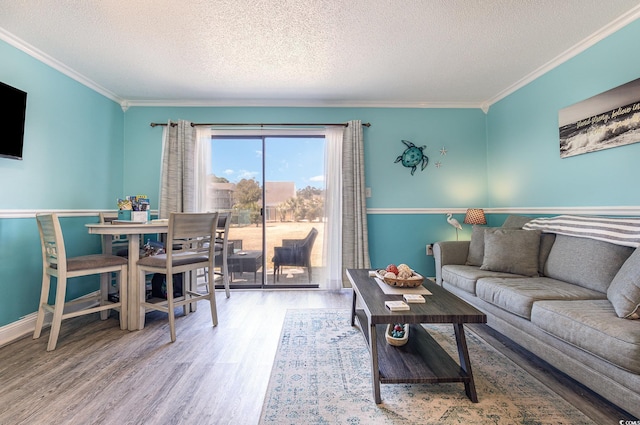 living area featuring crown molding, a textured ceiling, and wood finished floors