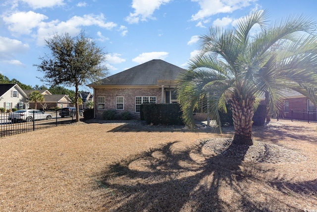 view of property exterior featuring fence and brick siding