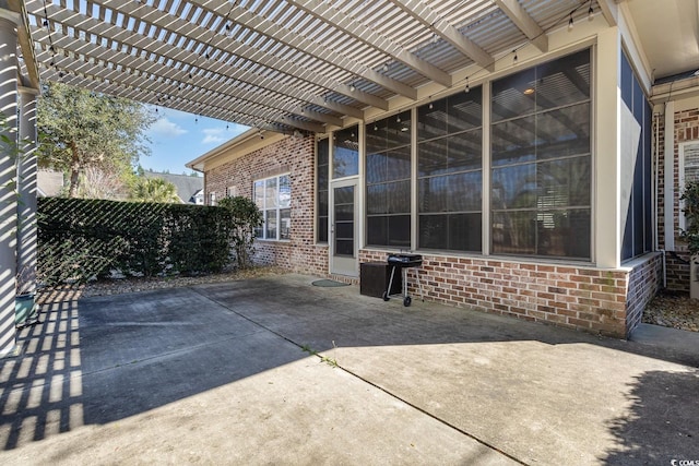 view of patio with grilling area and a pergola