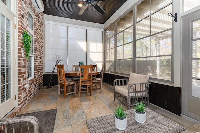 sunroom with a ceiling fan