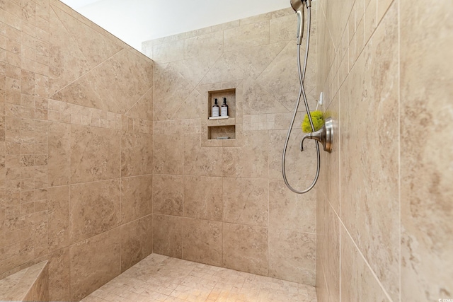 full bath with a tile shower