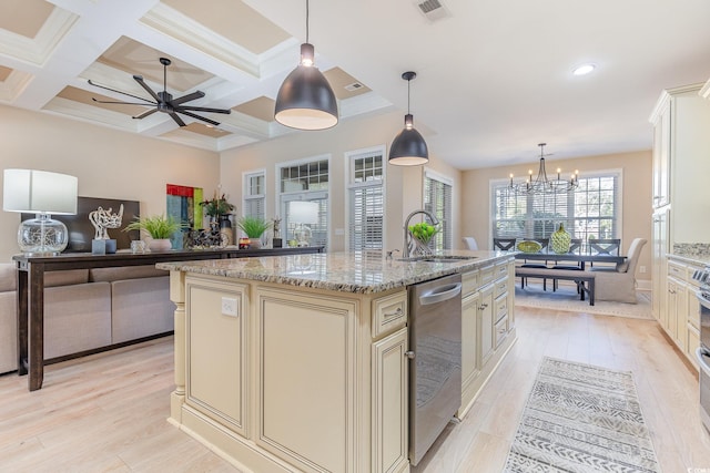 kitchen featuring visible vents, dishwasher, an island with sink, cream cabinetry, and a sink