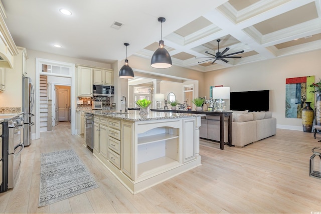 kitchen with cream cabinetry, visible vents, appliances with stainless steel finishes, light wood-style floors, and open floor plan