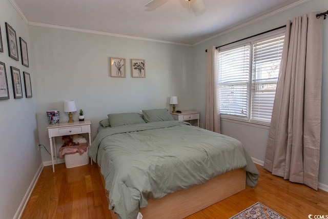 bedroom with ornamental molding, ceiling fan, light wood finished floors, and baseboards