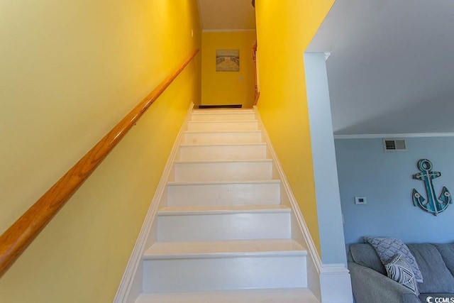 stairway with visible vents and crown molding