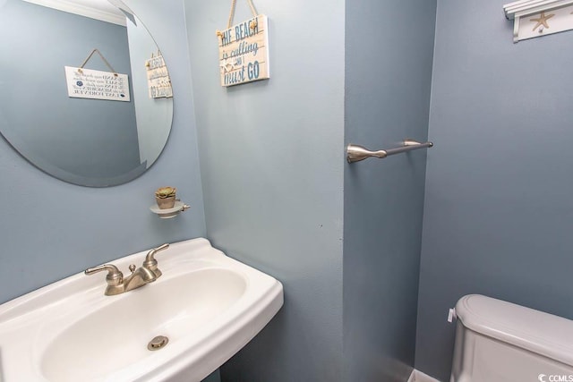 half bath with a sink and toilet