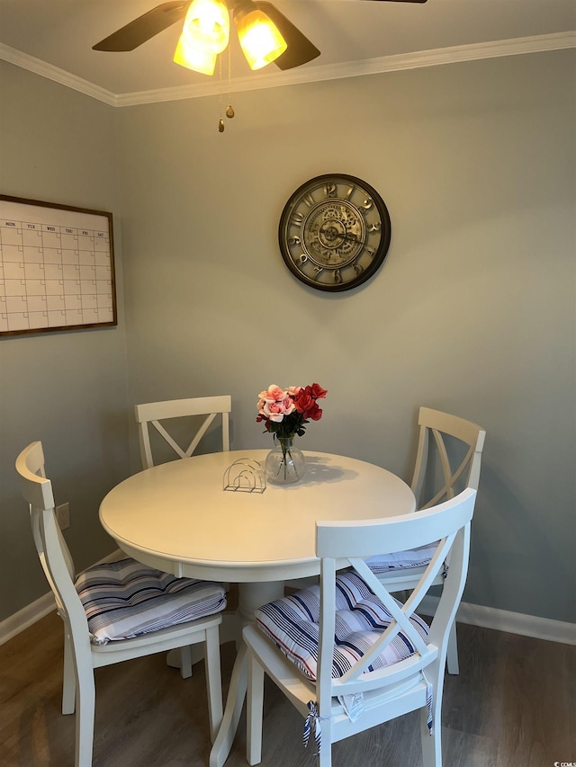 dining area with ornamental molding, wood finished floors, a ceiling fan, and baseboards