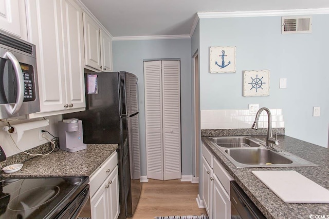 kitchen featuring black appliances, a sink, visible vents, and white cabinets