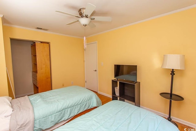 bedroom with a ceiling fan, visible vents, crown molding, and baseboards
