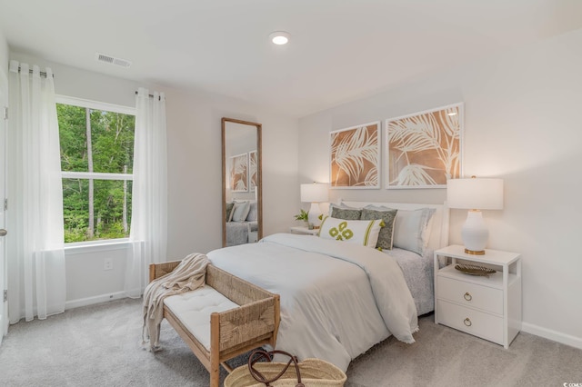 bedroom with baseboards, visible vents, and multiple windows