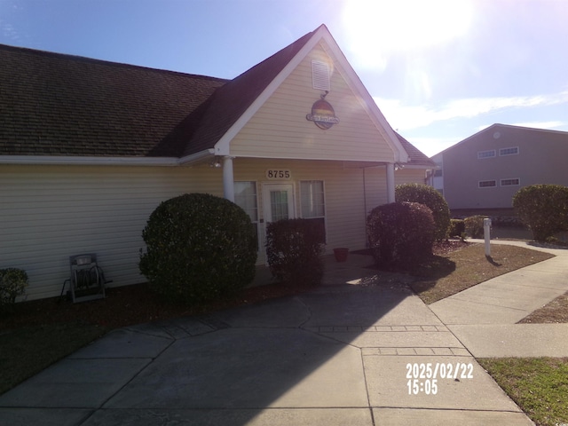 view of front of home featuring a shingled roof