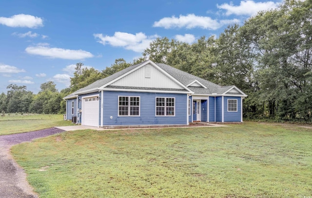 ranch-style home featuring driveway, a shingled roof, a front lawn, and an attached garage