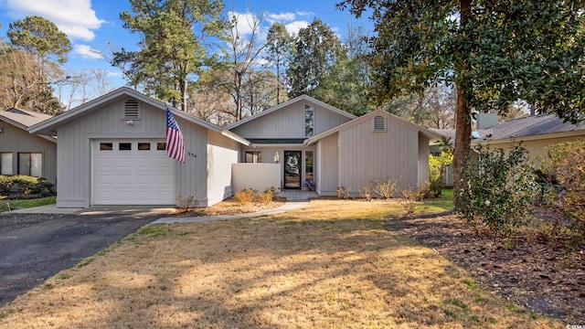 view of front of house with aphalt driveway and an attached garage