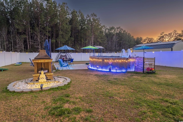 view of pool featuring a yard, a patio, a pool, and a fenced backyard