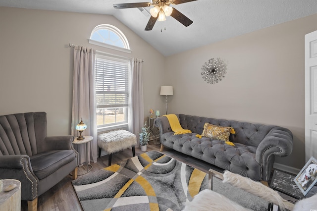 living room featuring a ceiling fan, wood finished floors, a healthy amount of sunlight, and vaulted ceiling