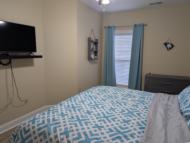 bedroom featuring visible vents and baseboards