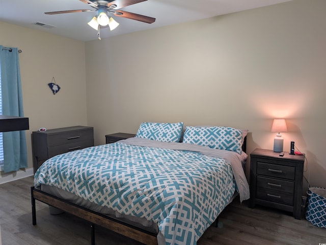 bedroom featuring visible vents, ceiling fan, and wood finished floors