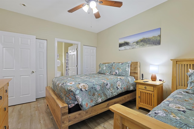 bedroom with a ceiling fan, connected bathroom, and light wood finished floors