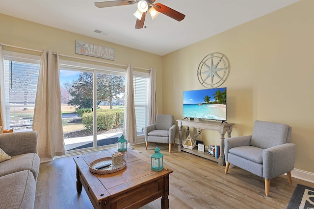 living area with a healthy amount of sunlight, visible vents, and light wood-style flooring