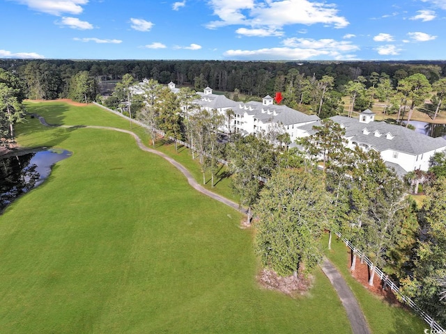 drone / aerial view with a water view and a forest view