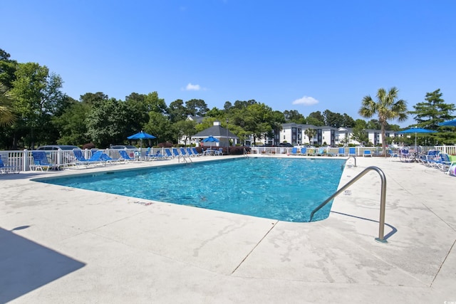 community pool featuring a patio and fence