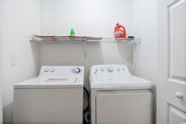 clothes washing area featuring laundry area and separate washer and dryer