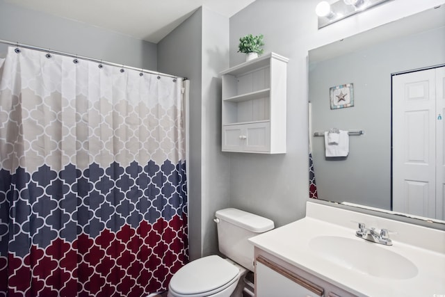 bathroom with toilet, vanity, and a shower with curtain