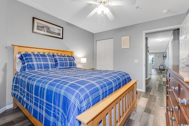 bedroom with a closet, baseboards, and wood finished floors