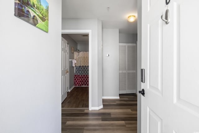 hall featuring baseboards and wood finished floors