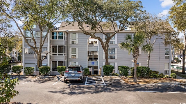 view of building exterior with uncovered parking