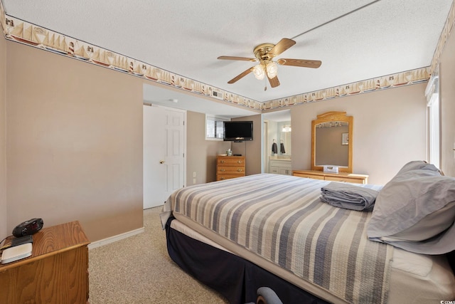 bedroom with a textured ceiling, ceiling fan, connected bathroom, baseboards, and carpet