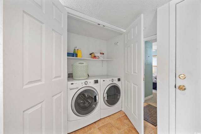 washroom with laundry area, independent washer and dryer, a textured ceiling, and light tile patterned floors